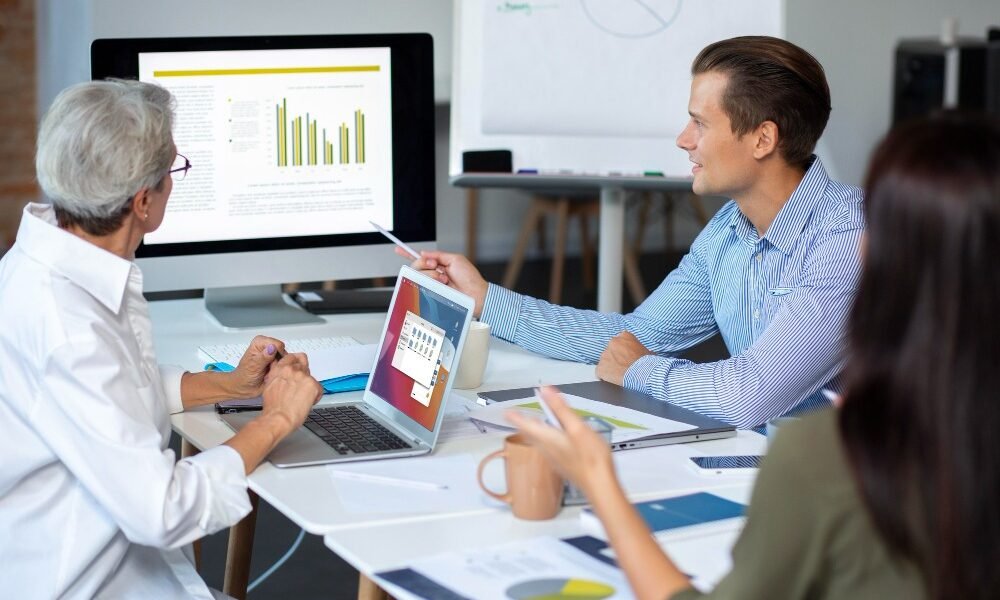 Healthcare market research team analyzing data and charts in a strategy meeting